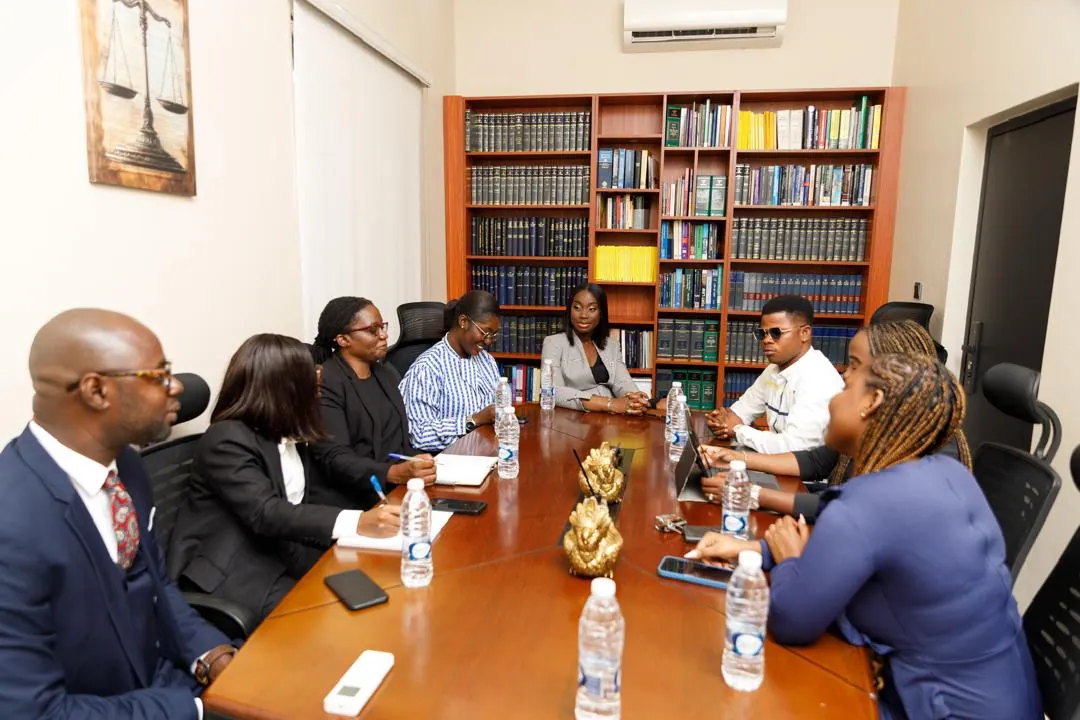 Lawyers of the firm in discussion around the boardroom table.