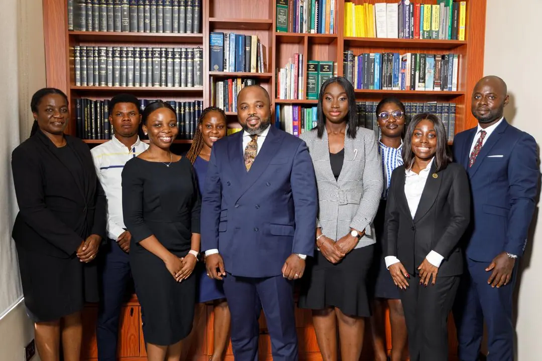 The lawyers of MacCarthy & Associates photographed together in the firm's law library.